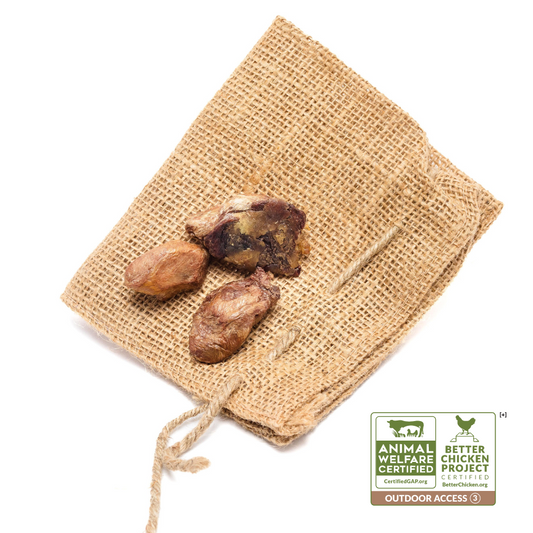 Three pieces of Beast Feast freeze-dried chicken hearts on a piece of burlap with a Certified Humane Raised & Handled logo.