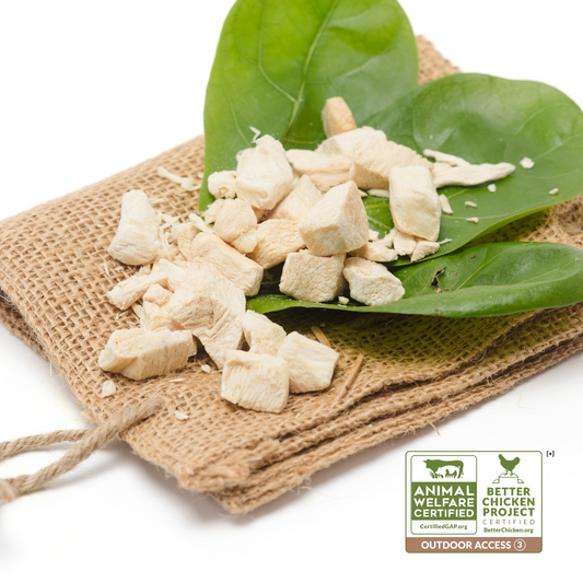 Sentence with product replaced:
Diced Beast Feast freeze-dried chicken breast pieces on a burlap cloth with green leaves, featuring Certified Humane raised labels.