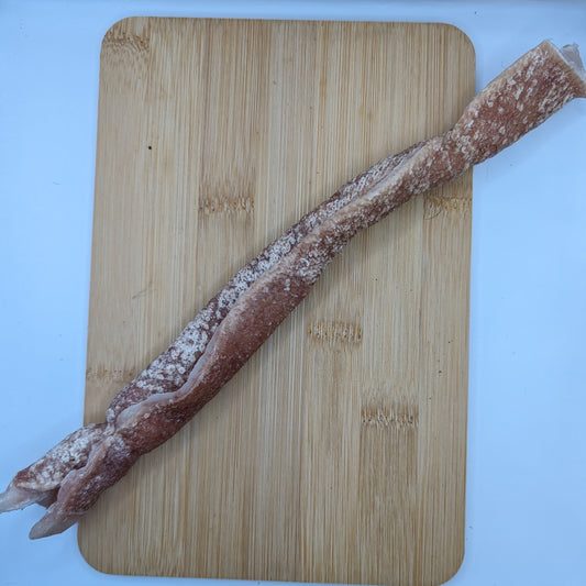A Beast Feast heritage breed freeze-dried pork roll sits on a cutting board.