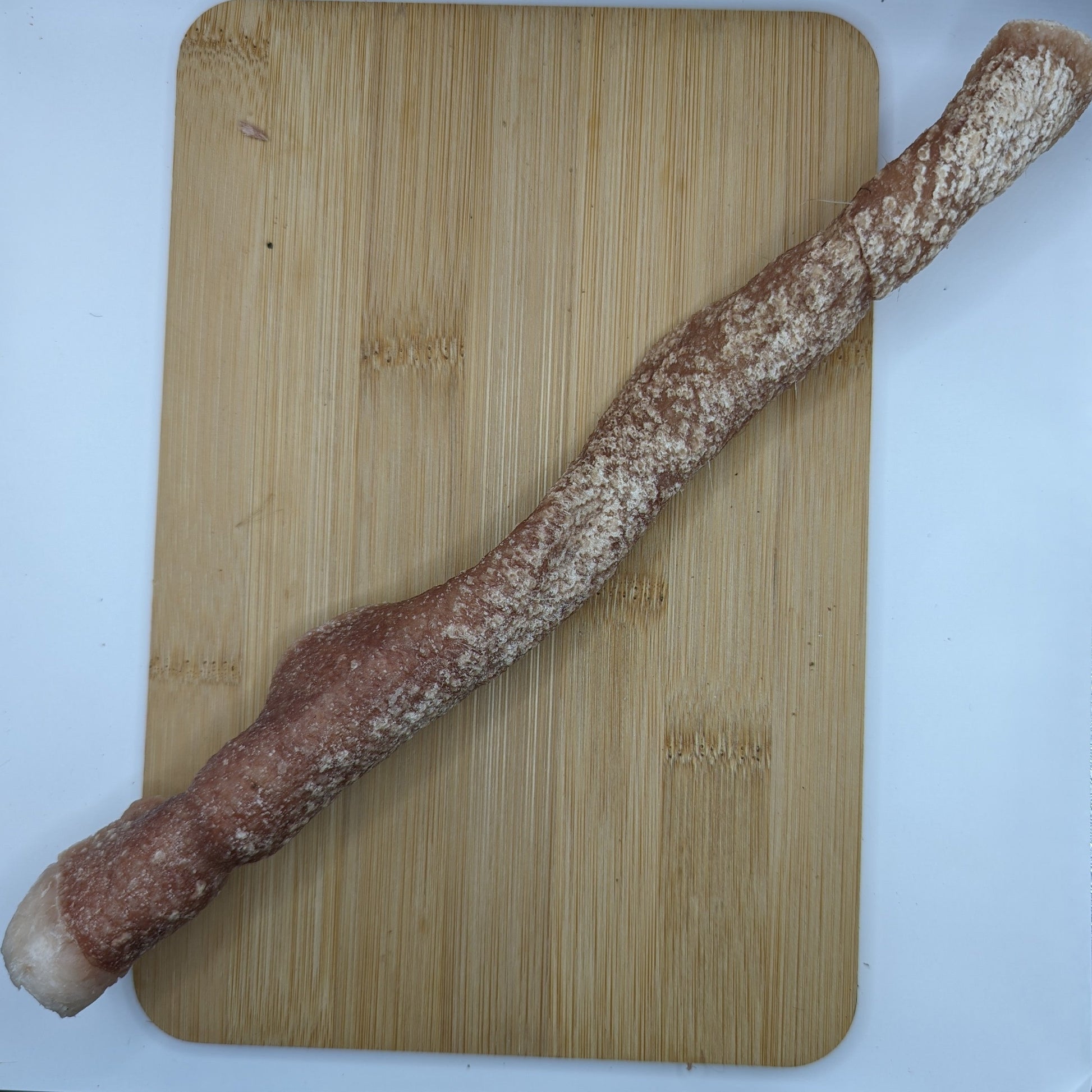 A Beast Feast heritage breed freeze-dried pork roll on a cutting board.