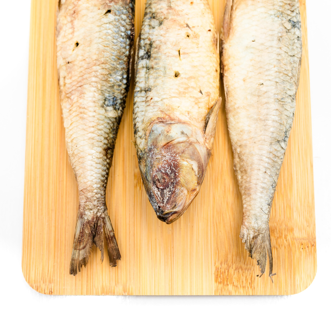 Three protein-rich Freeze-Dried Sardines from Beast Feast on a wooden cutting board.