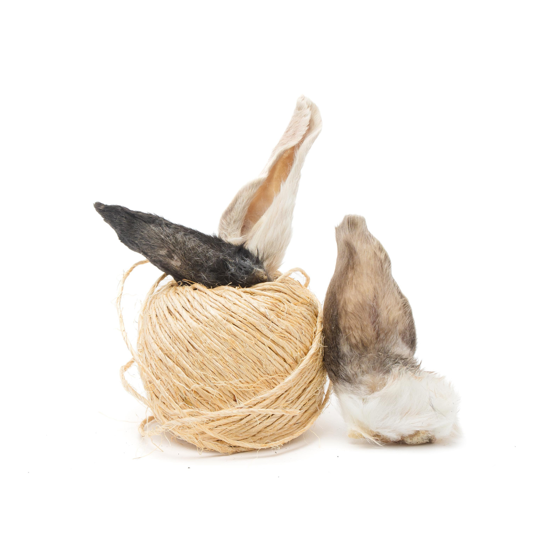 Beast Feast Freeze-Dried Rabbit Ear tails, rabbits ears, and novel protein in a ball on a white background.