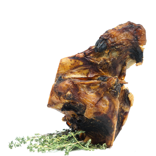 A savory piece of Beast Feast Smoked Bison Knuckle Bones seasoned with aromatic herbs.