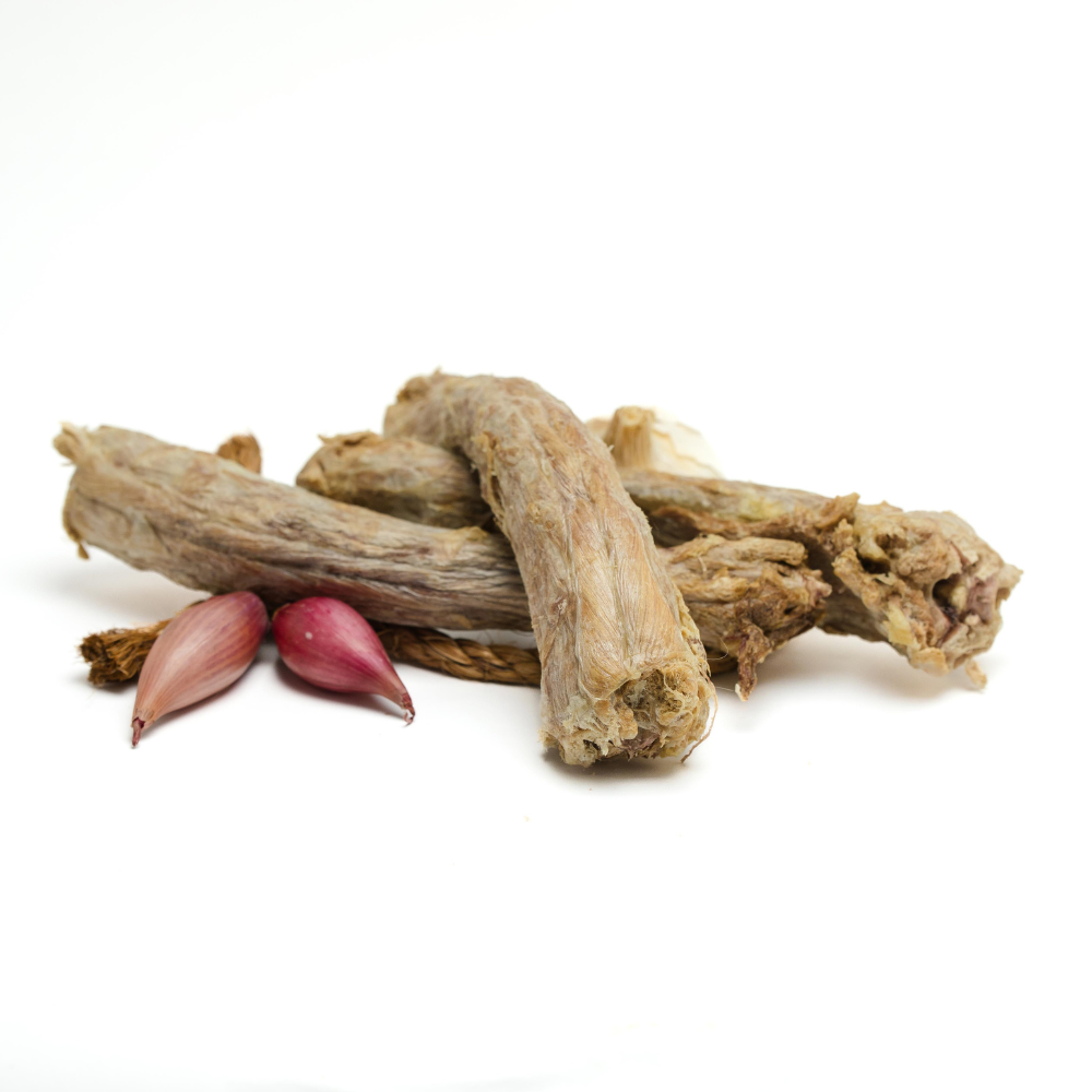 A pile of sticks and garlic on a white background, accompanied by Beast Feast's Organic Freeze-Dried Turkey Necks for a non-GMO diet.