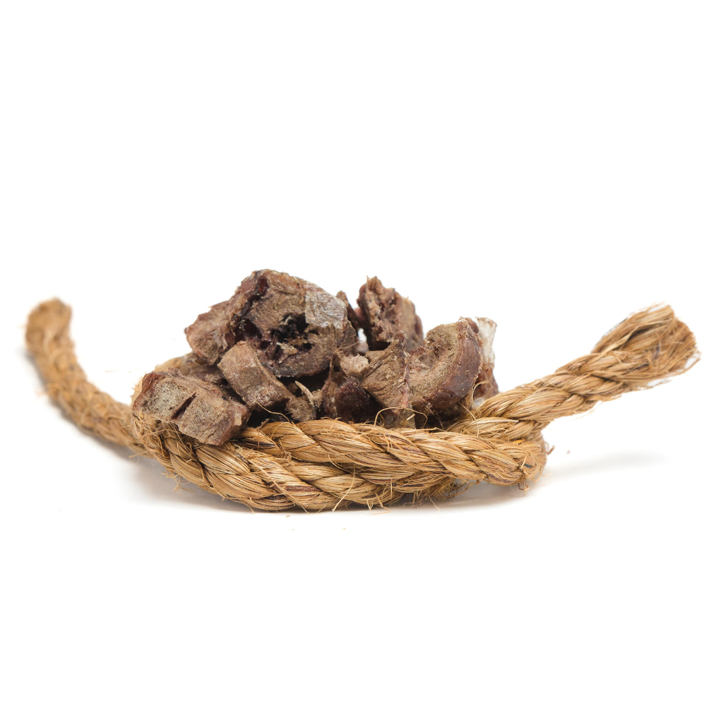 A pile of Beast Feast Organic Freeze-Dried Turkey Hearts (cubed) 3oz on a rope on a white background.