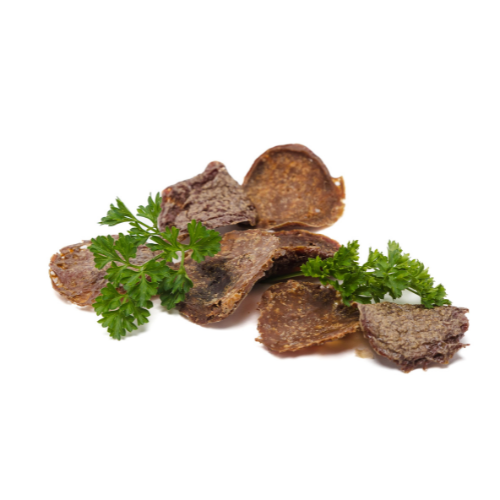 A pile of Beast Feast Bison Crispers, high in protein, with parsley on a white background.