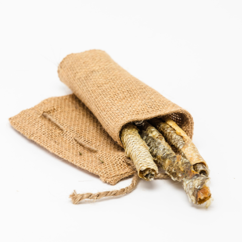 A bundle of sticks, resembling a Beast Feast Carp Skin Roll, contained in a burlap bag on a white background.