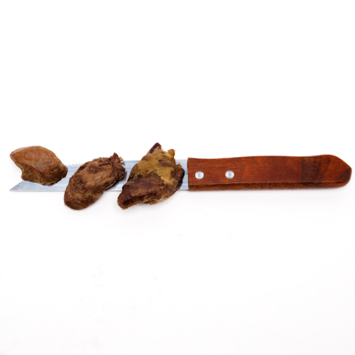 A knife with Beast Feast Freeze-Dried Chicken Hearts 3oz containing essential amino acids on it.